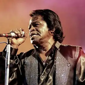 Frontman James Brown singing on stage