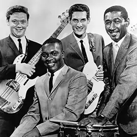 Booker T & The MGs band posing with instruments