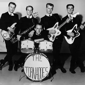 The Tornadoes band posing with instruments