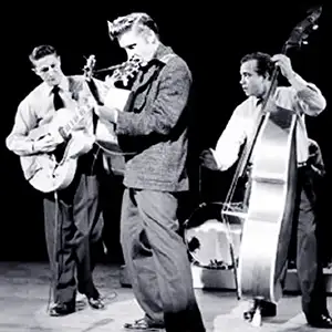 Elvis Presley, Scotty, and Bill on stage