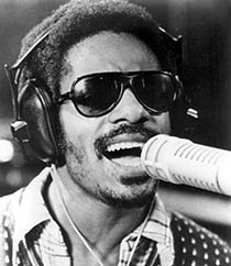 Soul singer Stevie Wonder singing and wearing headphones